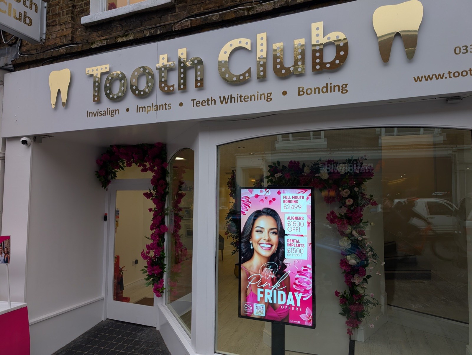 Window-facing screen in a dental practice shopfront.